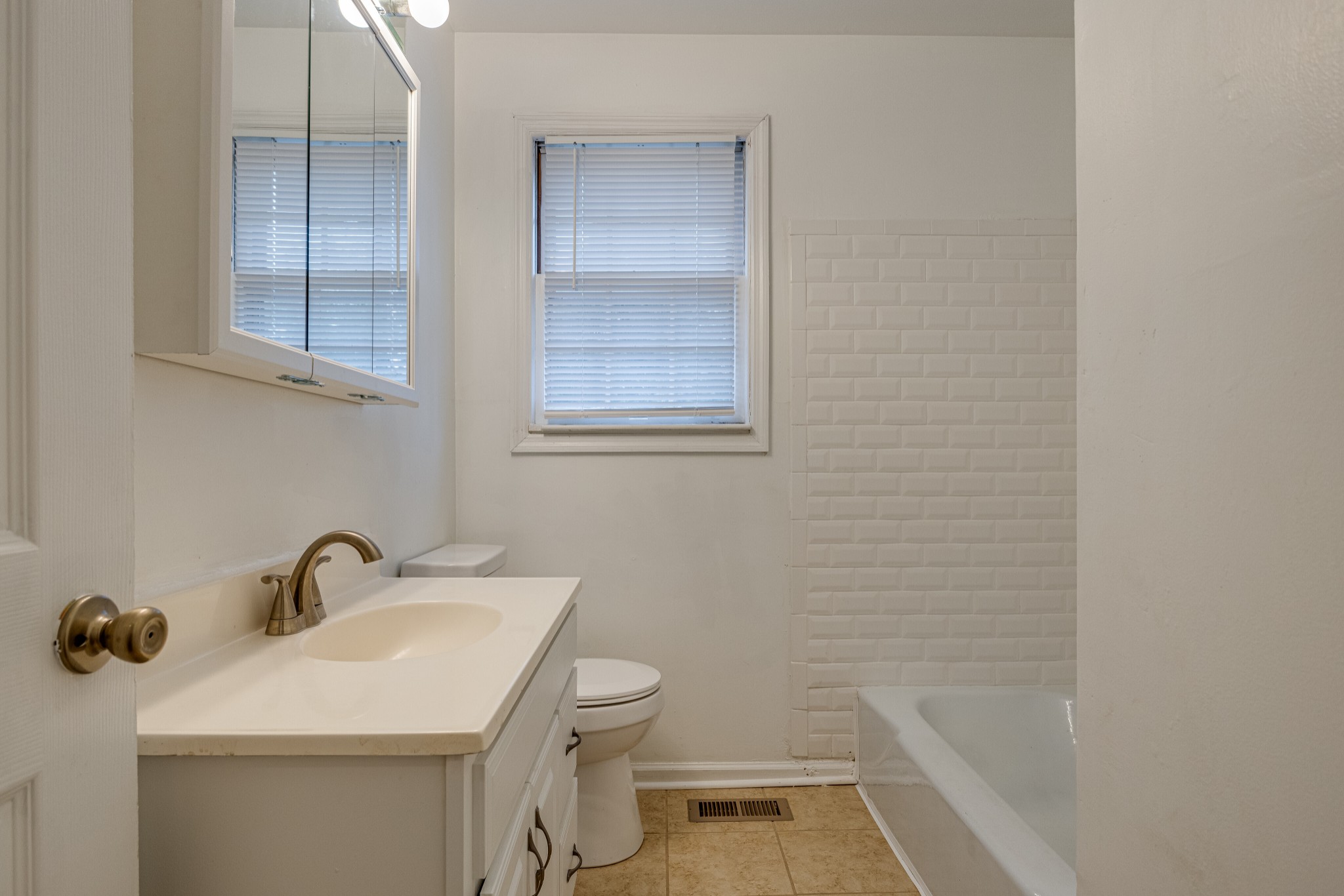 76 Tusculum Road Antioch, TN 37013 - Photo 17 of 33 a bathroom with a sink and a bathtub