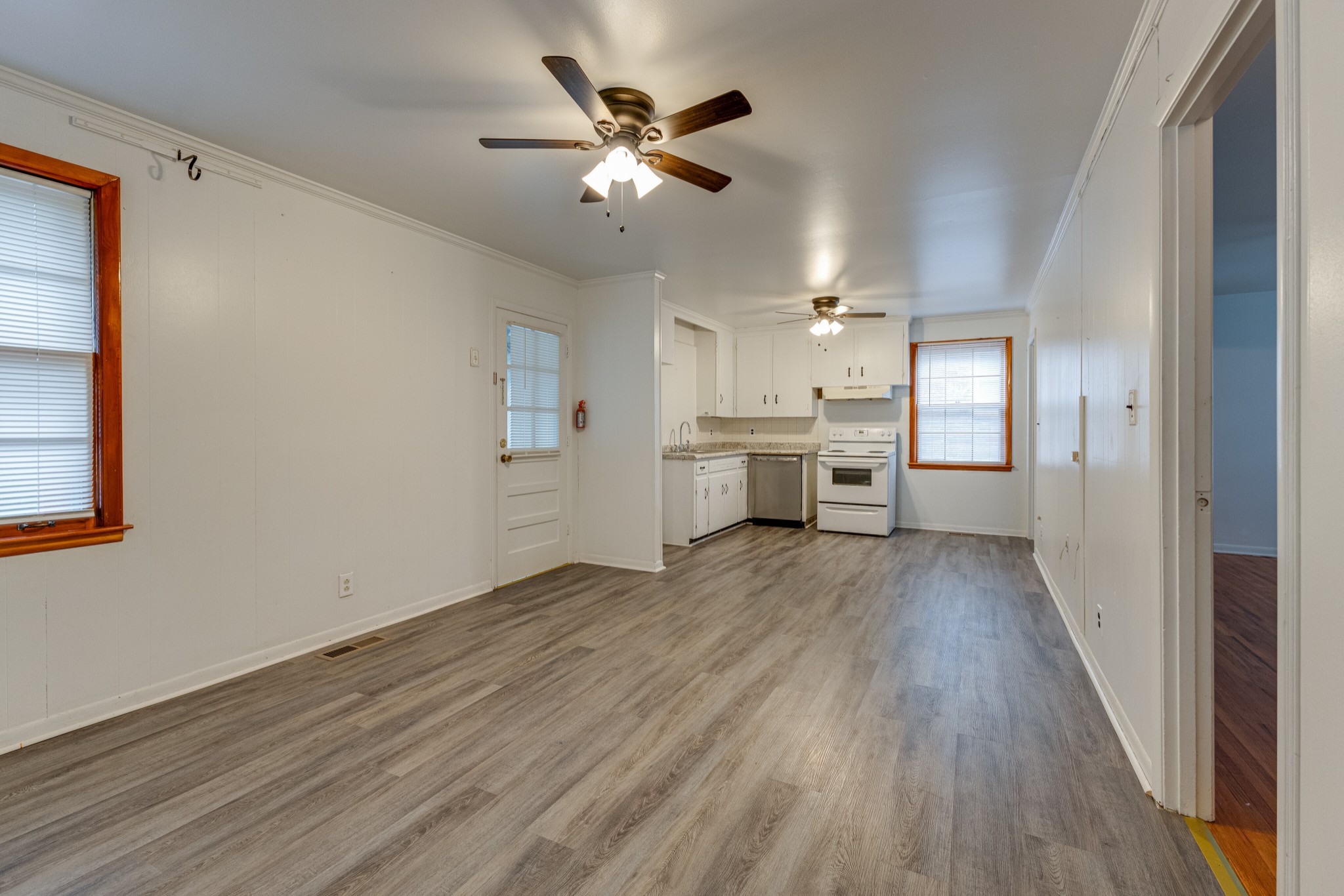 76 Tusculum Road Antioch, TN 37013 - Photo 9 of 33 a view of a kitchen with a stove cabinets a ceiling fan and wooden floor