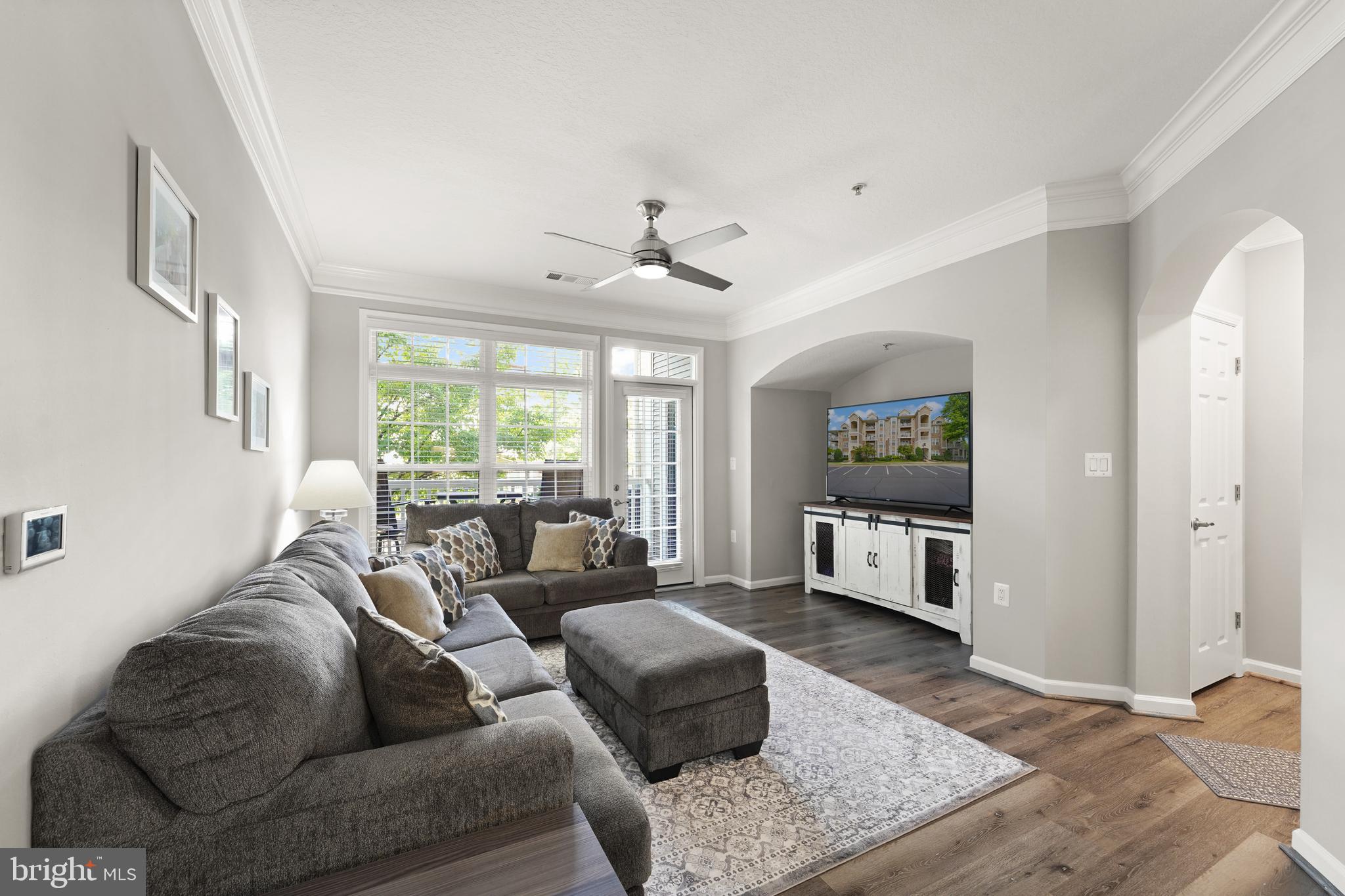 502 Sunset View Terrace Southeast, Unit 107 Leesburg, VA 20175 - Photo 11 of 50 a living room with furniture ceiling fan and a window
