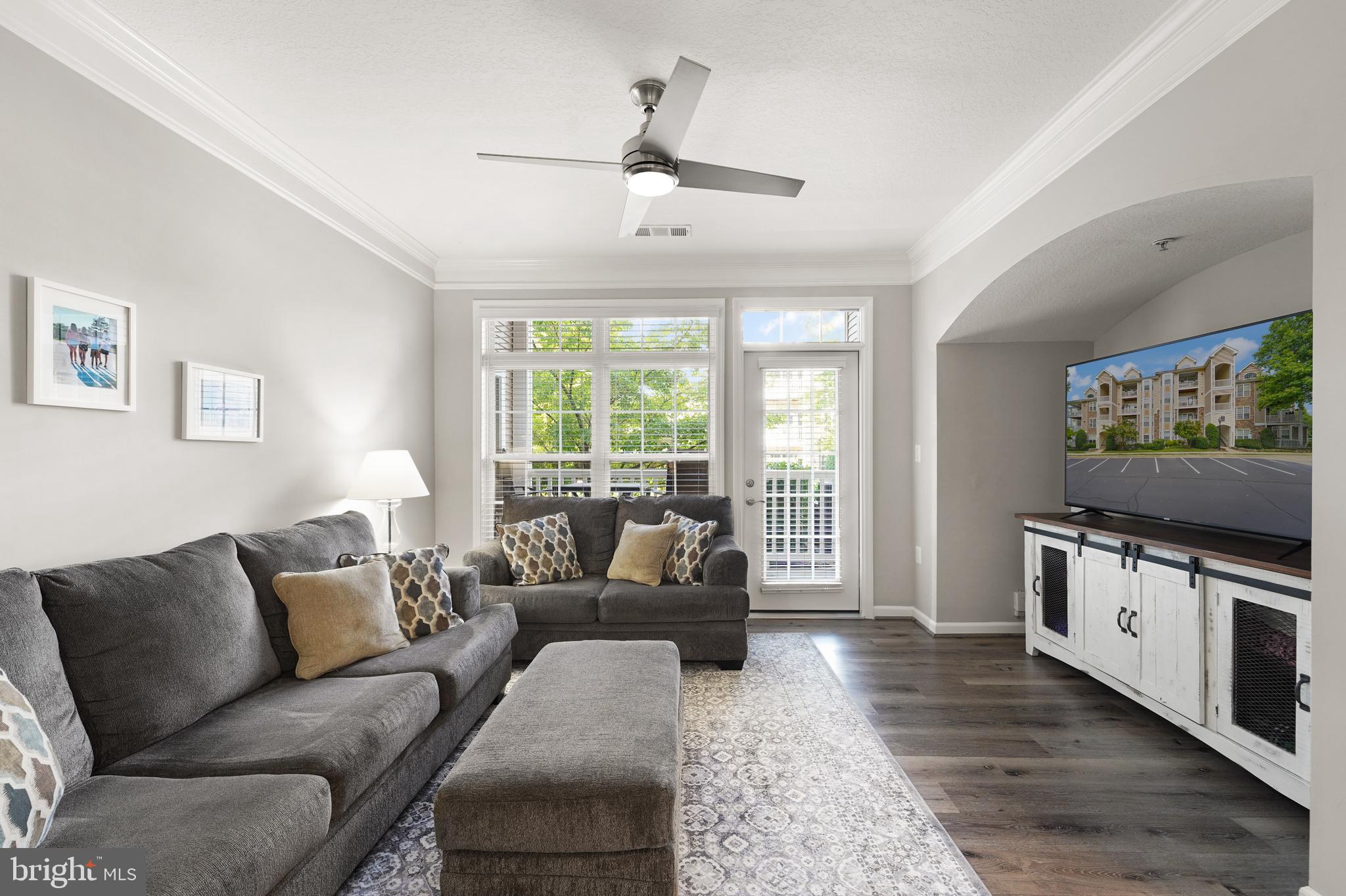 502 Sunset View Terrace Southeast, Unit 107 Leesburg, VA 20175 - Photo 12 of 50 a living room with furniture and a flat screen tv