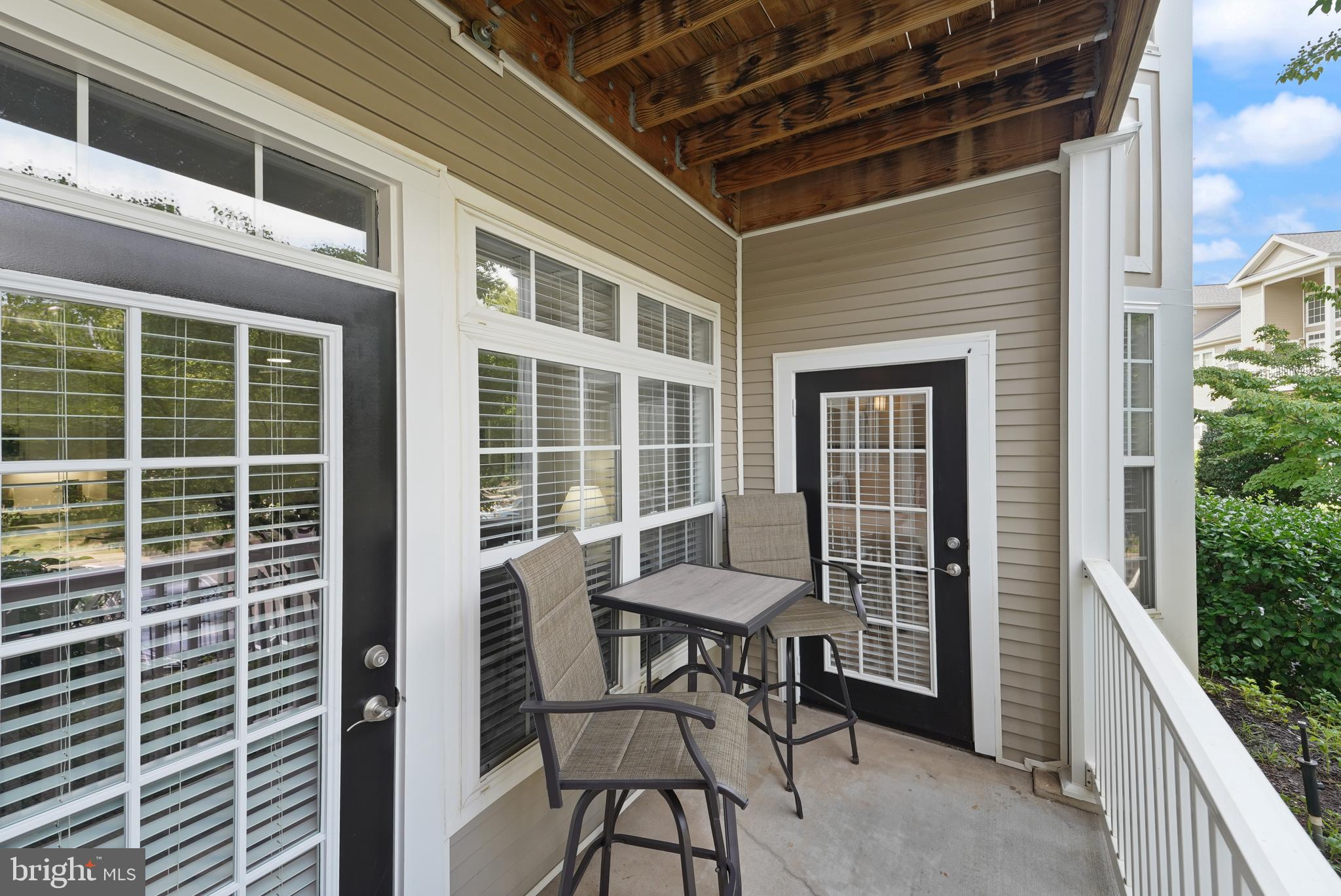 502 Sunset View Terrace Southeast, Unit 107 Leesburg, VA 20175 - Photo 15 of 50 a balcony with table and chairs