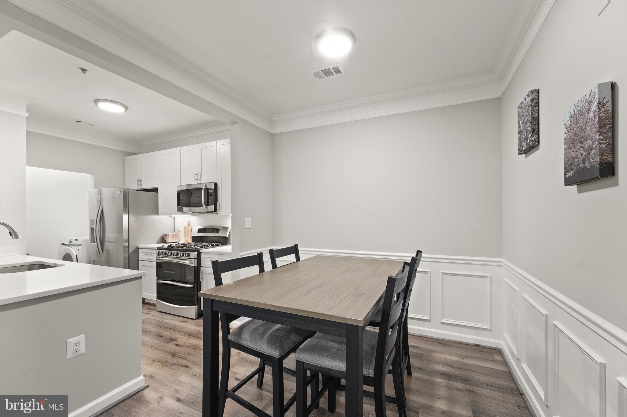 502 Sunset View Terrace Southeast, Unit 107 Leesburg, VA 20175 - Photo 19 of 50 a view of a dining room with furniture and wooden floor