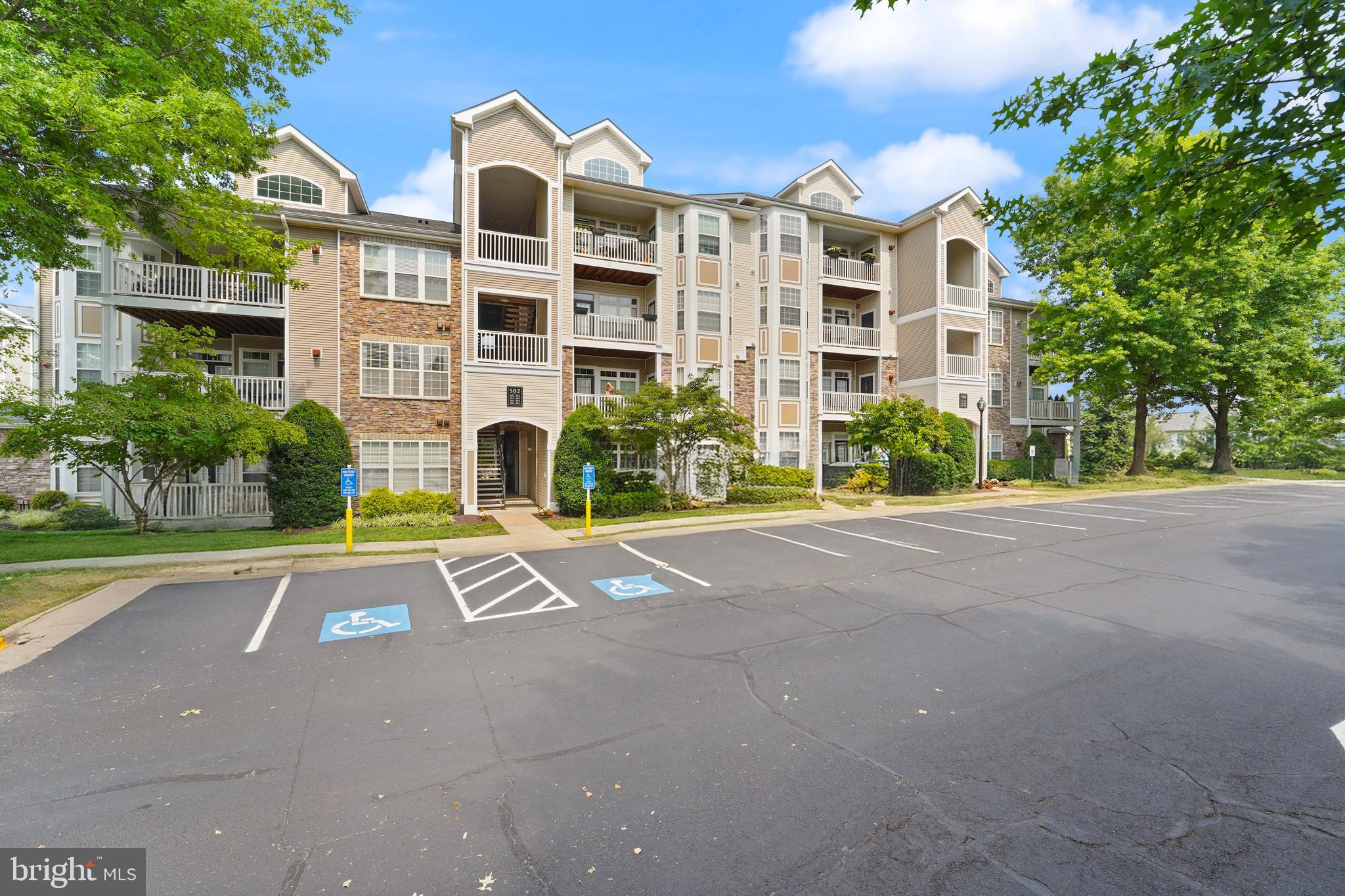 502 Sunset View Terrace Southeast, Unit 107 Leesburg, VA 20175 - Photo 2 of 50 a view of a building with a yard