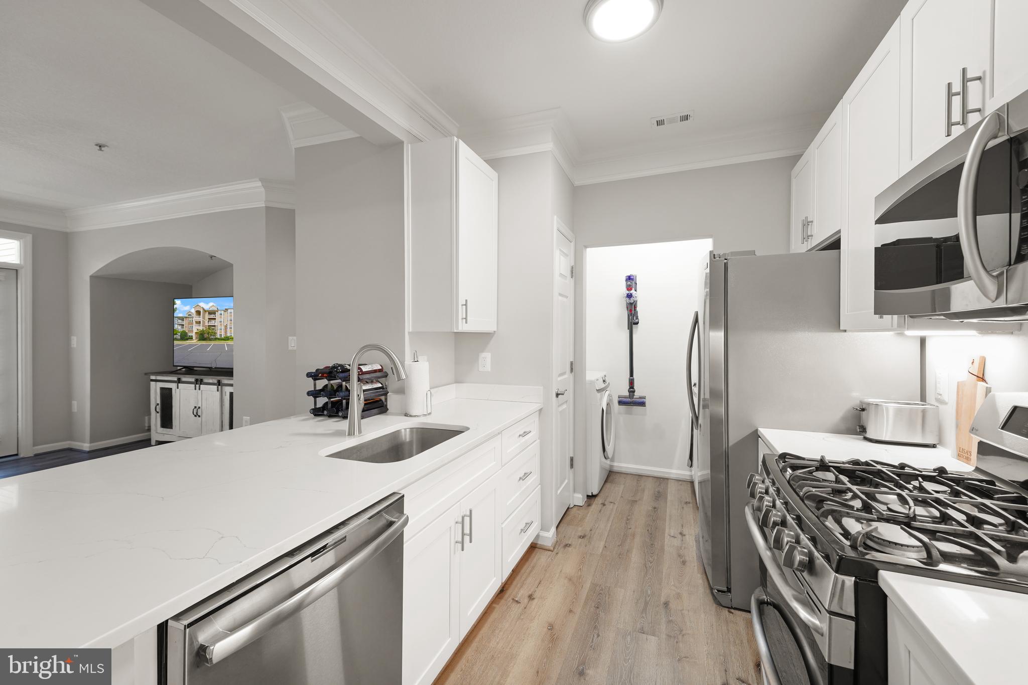 502 Sunset View Terrace Southeast, Unit 107 Leesburg, VA 20175 - Photo 22 of 50 a kitchen with a sink stove and refrigerator