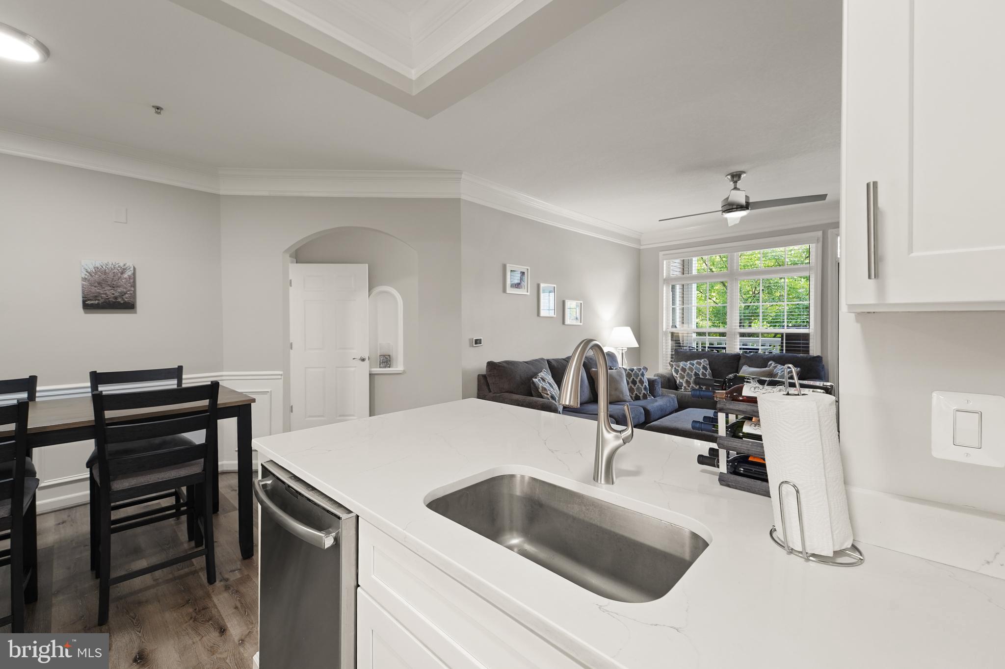 502 Sunset View Terrace Southeast, Unit 107 Leesburg, VA 20175 - Photo 24 of 50 a kitchen with a sink and a refrigerator