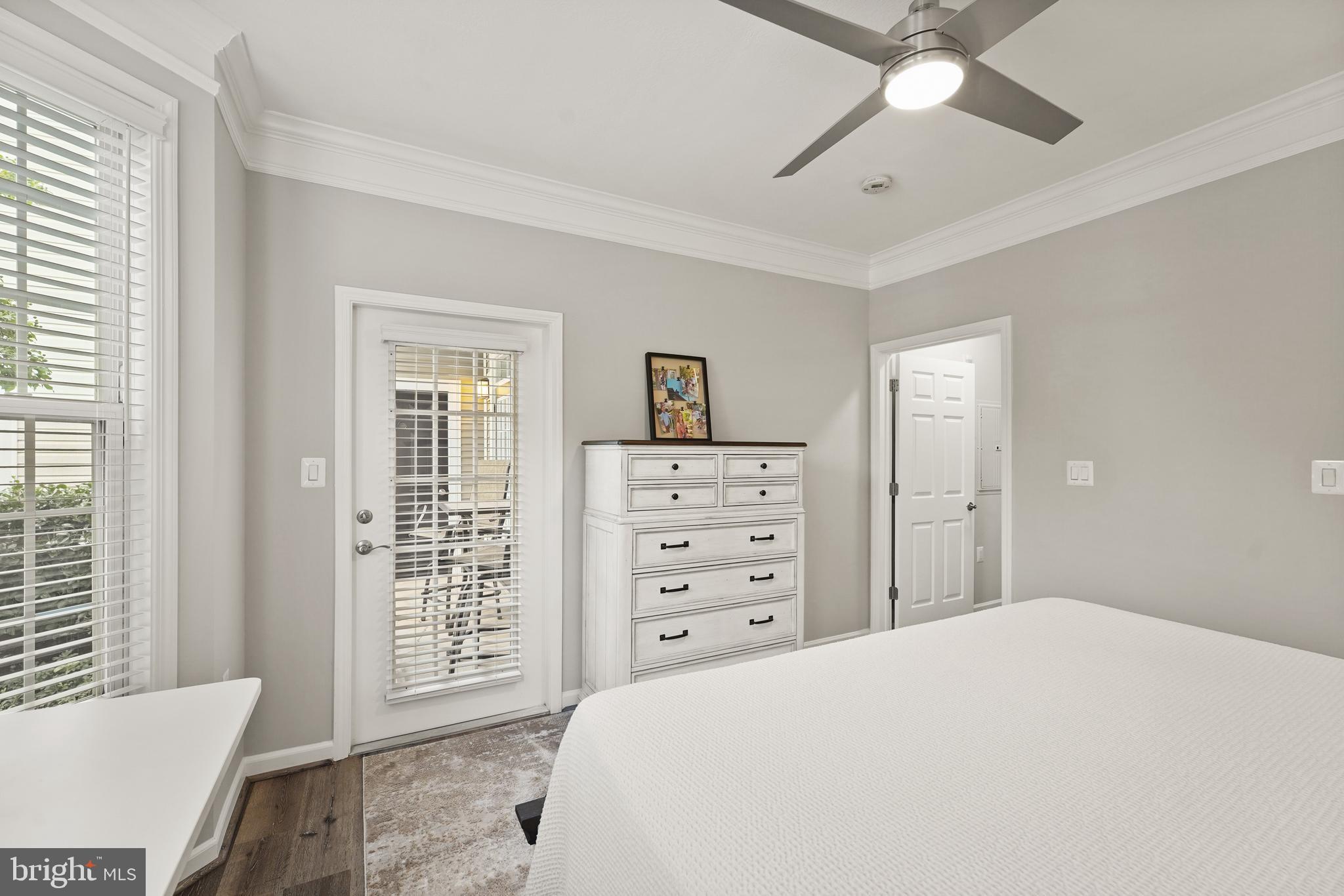502 Sunset View Terrace Southeast, Unit 107 Leesburg, VA 20175 - Photo 28 of 50 a bedroom with a bed and a chandelier