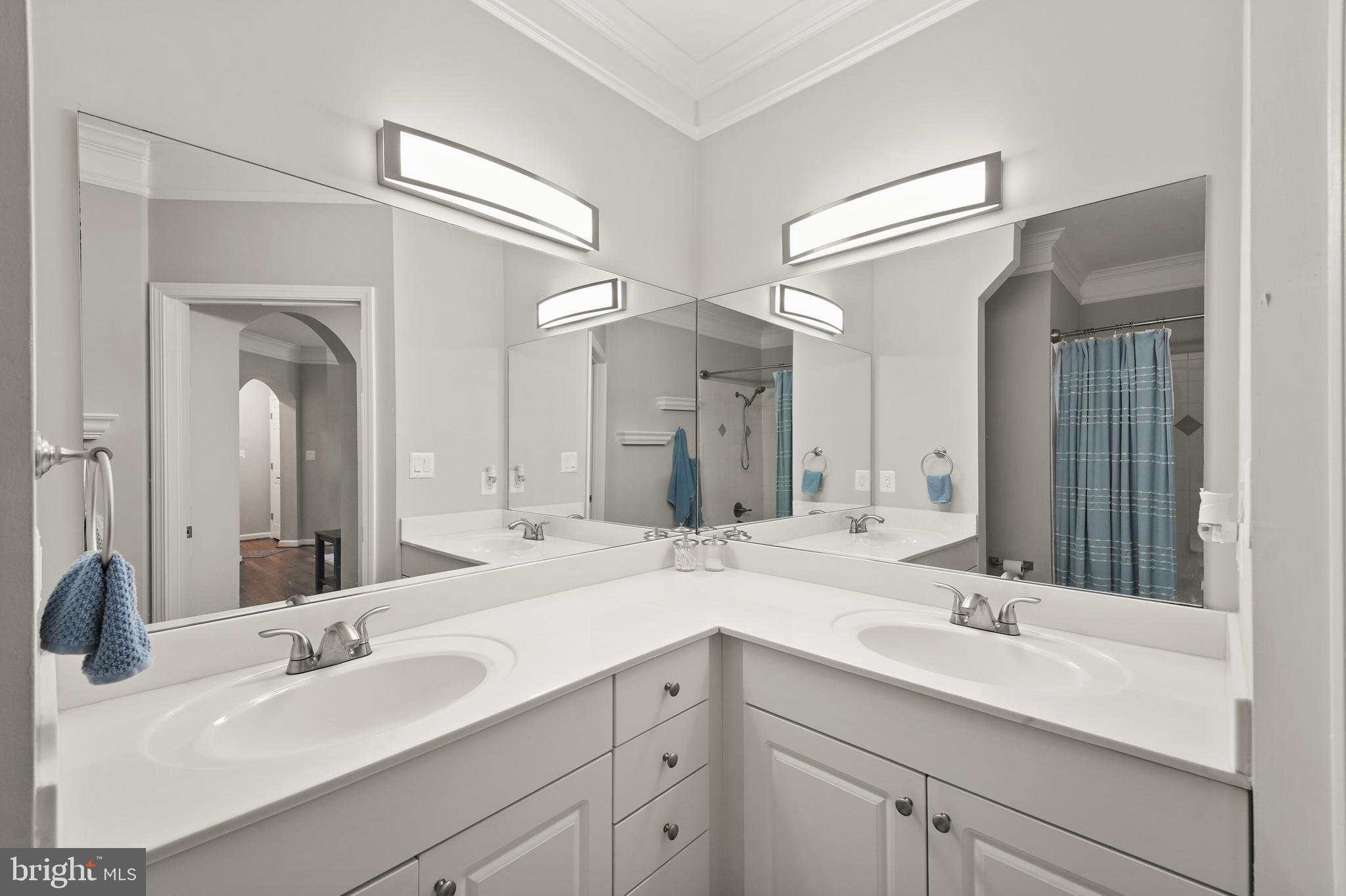 502 Sunset View Terrace Southeast, Unit 107 Leesburg, VA 20175 - Photo 30 of 50 a bathroom with double vanity sinks and a large mirror