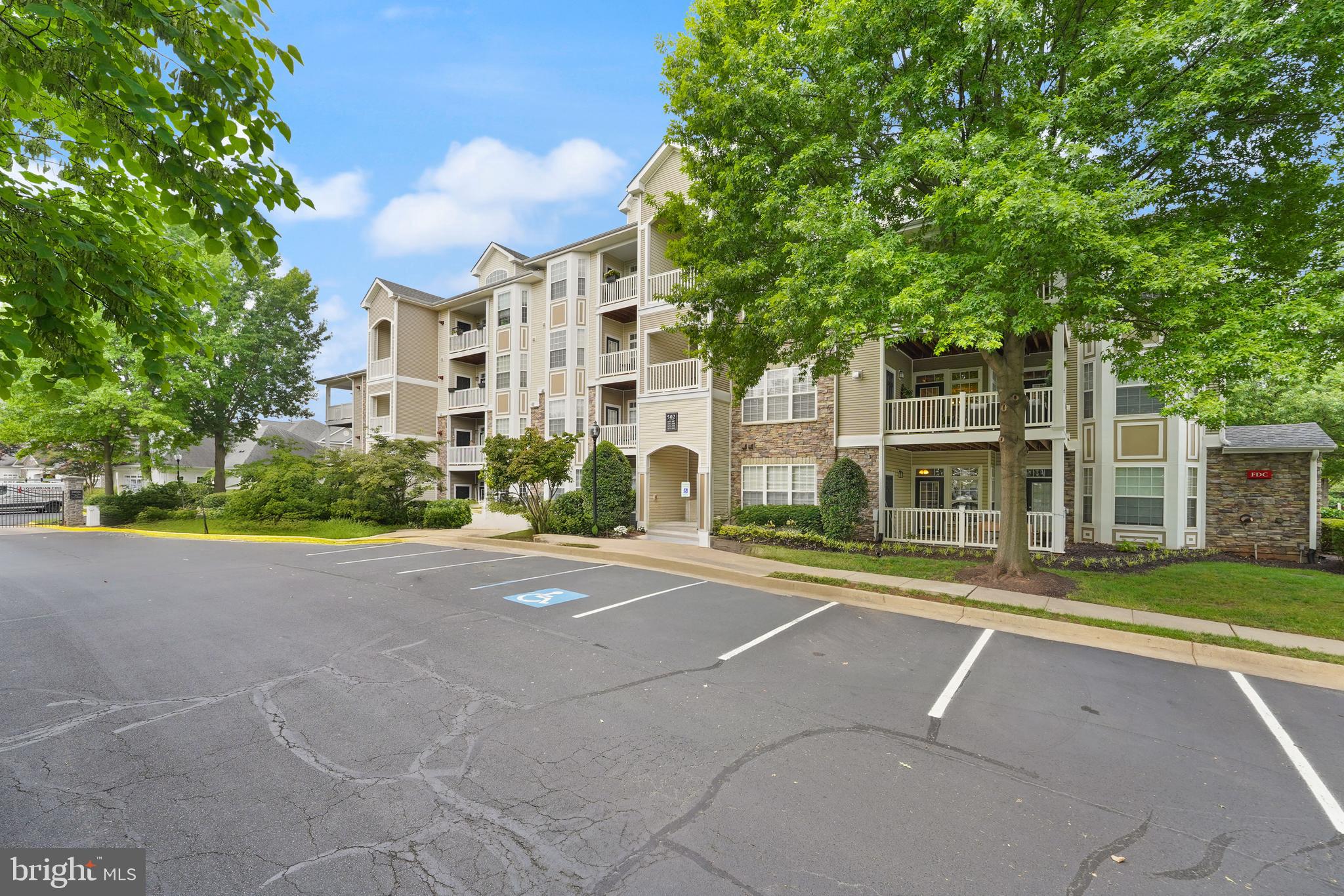 502 Sunset View Terrace Southeast, Unit 107 Leesburg, VA 20175 - Photo 3 of 50 a view of a building with a yard
