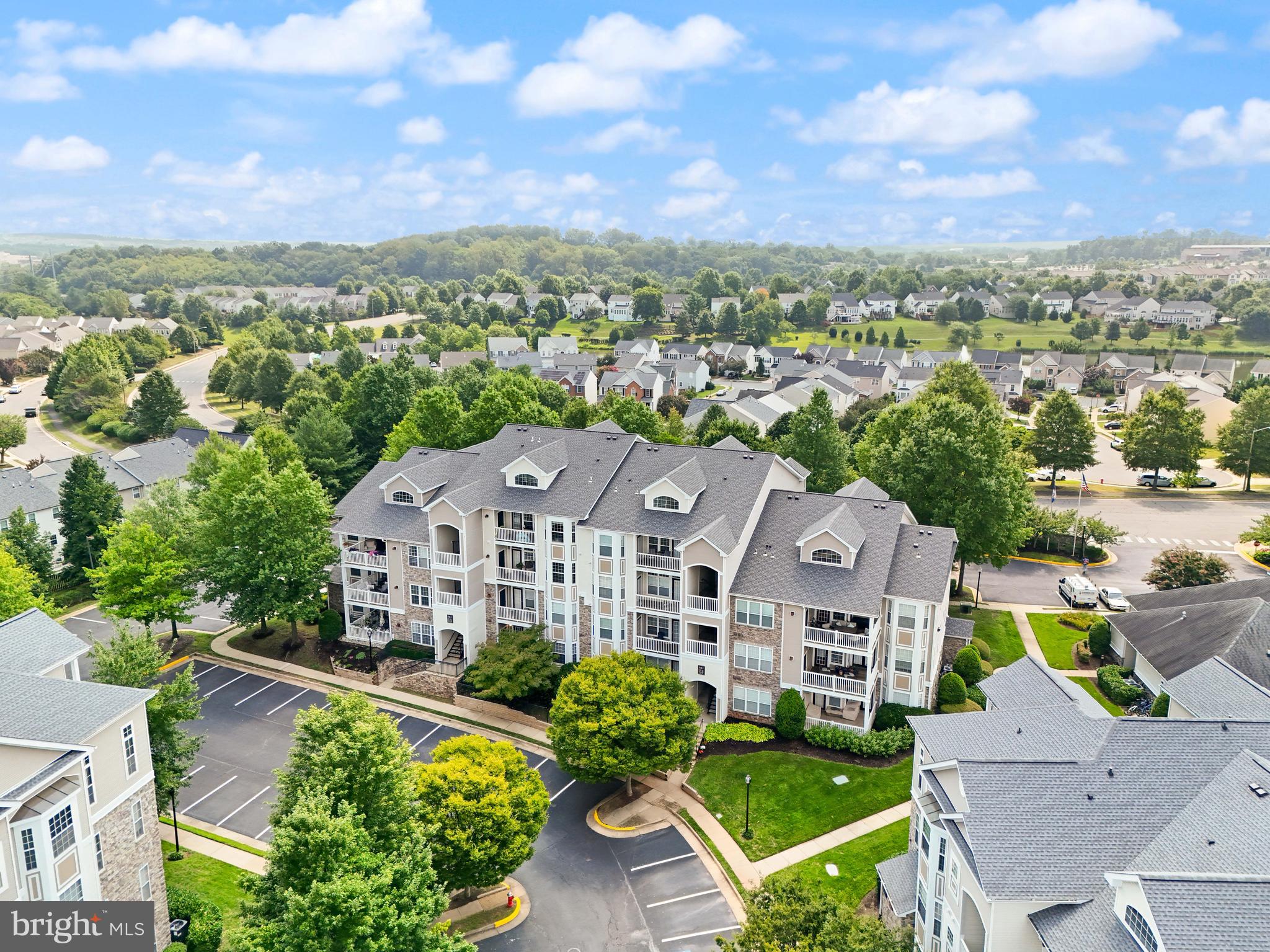 502 Sunset View Terrace Southeast, Unit 107 Leesburg, VA 20175 - Photo 35 of 50 an aerial view of multiple houses with a yard