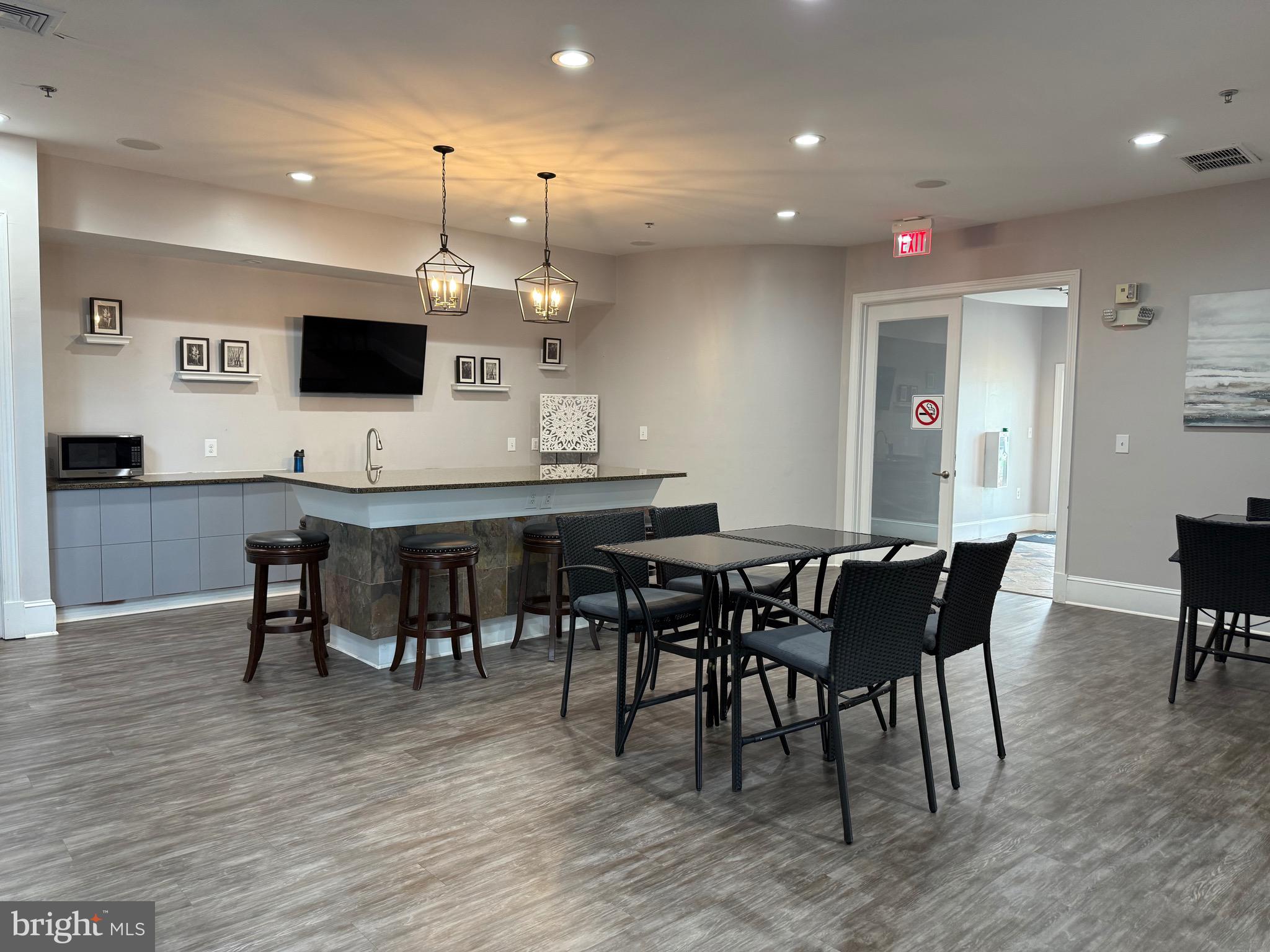 502 Sunset View Terrace Southeast, Unit 107 Leesburg, VA 20175 - Photo 39 of 50 a view of a dining area with furniture and wooden floor