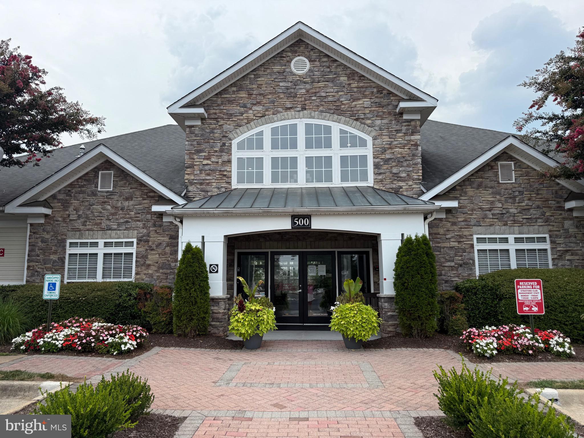 502 Sunset View Terrace Southeast, Unit 107 Leesburg, VA 20175 - Photo 40 of 50 a front view of a house with garden