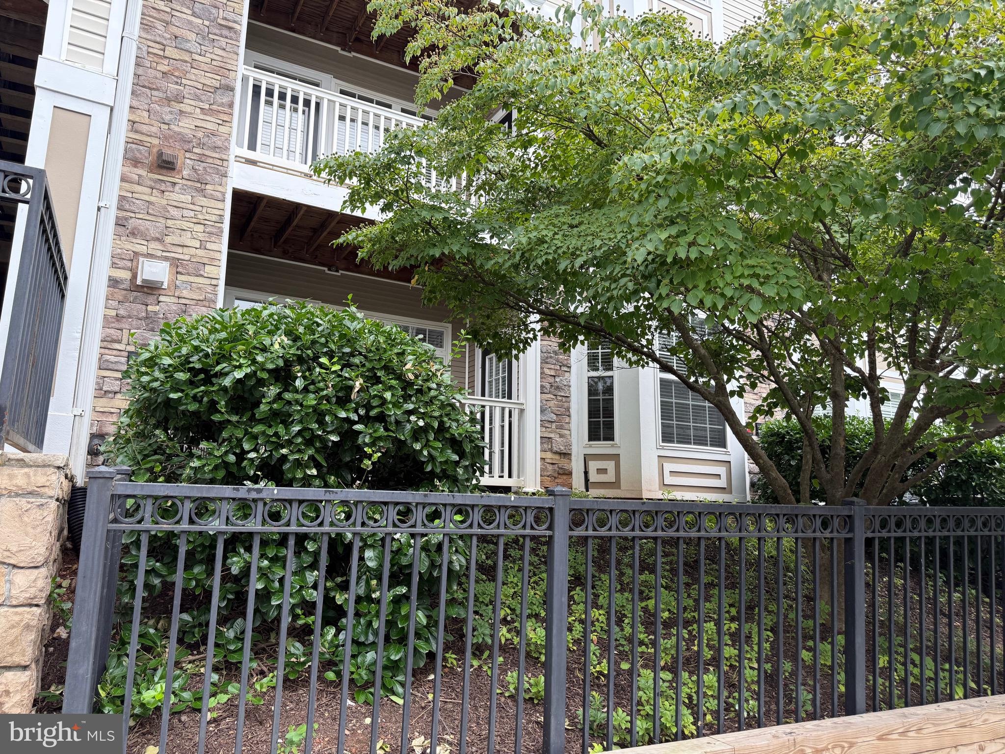 502 Sunset View Terrace Southeast, Unit 107 Leesburg, VA 20175 - Photo 43 of 50 a house view with a garden