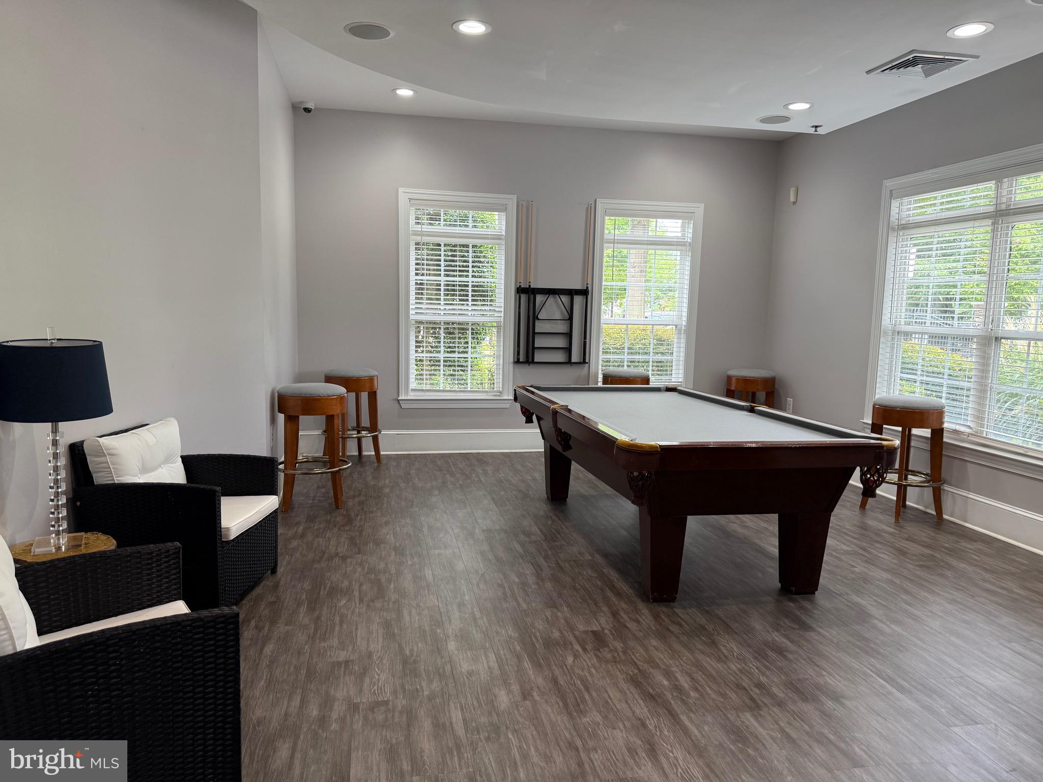 502 Sunset View Terrace Southeast, Unit 107 Leesburg, VA 20175 - Photo 49 of 50 a room with furniture pool table wooden floor and windows