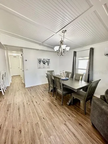a view of a dining room with furniture and chandelier