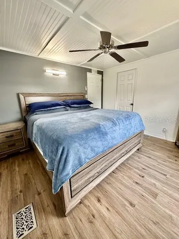 a bedroom with a bed and ceiling fan