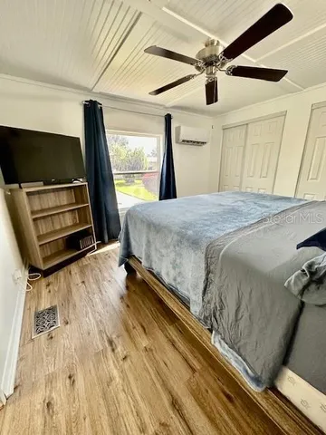 a bedroom with a bed and a flat tv screen