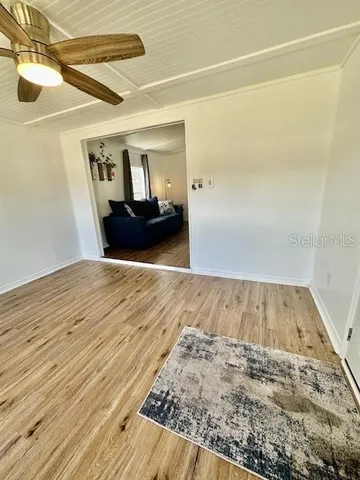 a view of a room with wooden floor
