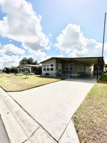 a view of swimming pool with outdoor seating and mountain view in back