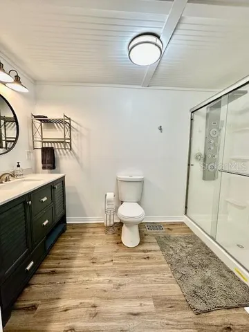 a bathroom with a sink mirror and toilet