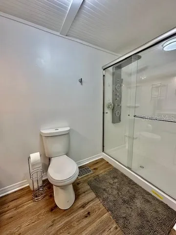 a bathroom with a toilet and a shower