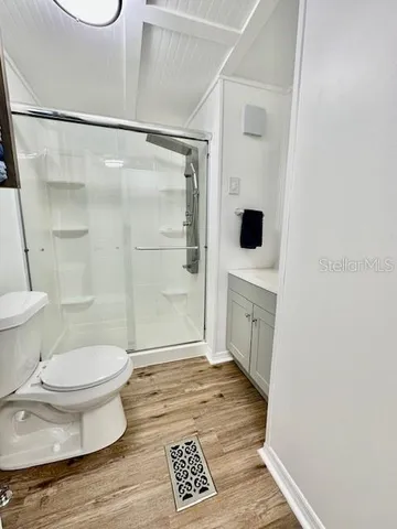 a bathroom with a toilet and a shower