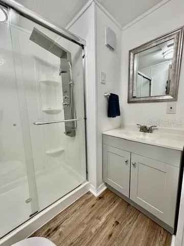 a bathroom with a double vanity sink mirror and shower