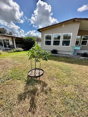 a front view of a house with a yard table and chairs