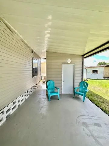 a view of a patio with two chairs and a table