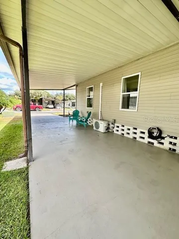 a view of a porch with chairs and backyard