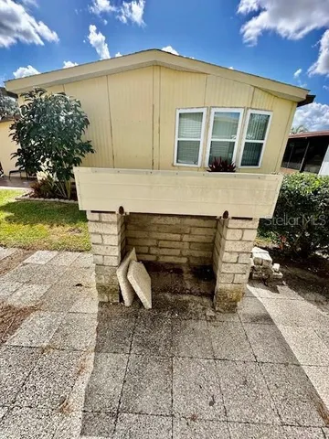 a view of a patio with table and chairs and potted plants