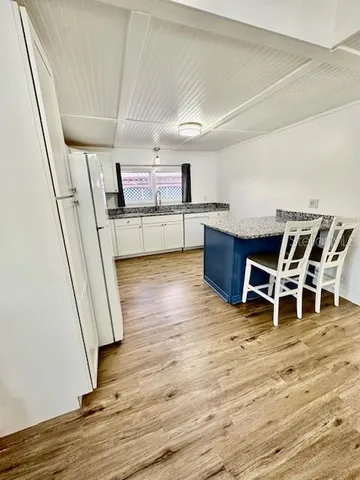 a room with wooden floor and furniture