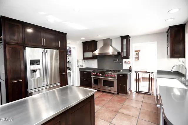 a dining room with furniture and a floor to ceiling window