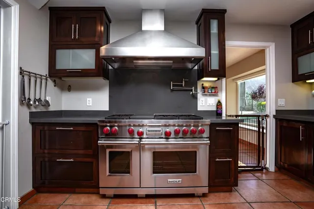 a view of a patio with table and chairs under an umbrella