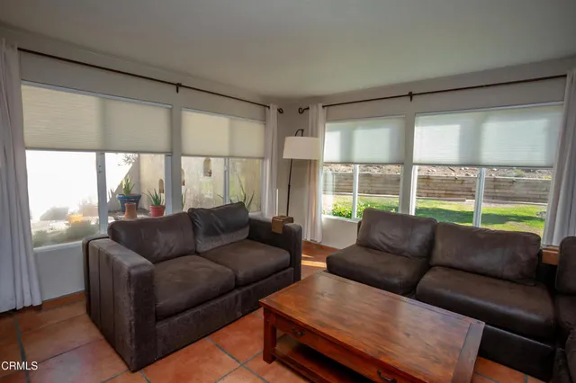 a bedroom with a bed and a flat tv screen next to a window