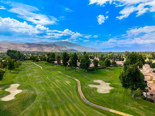 a view of a golf course with outside space