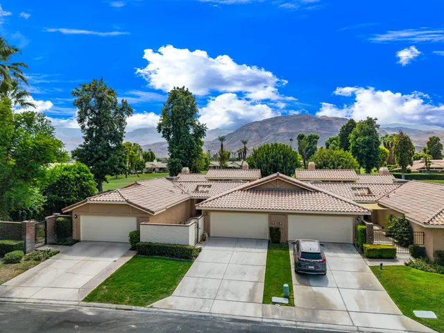 a view of a patio with a table and chairs under an umbrella