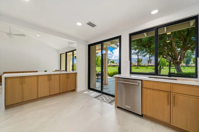 a view of open kitchen with large windows