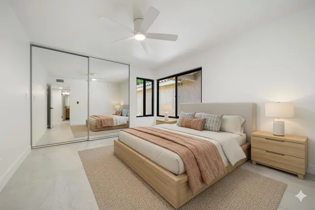 a bedroom with a large bed and a chandelier