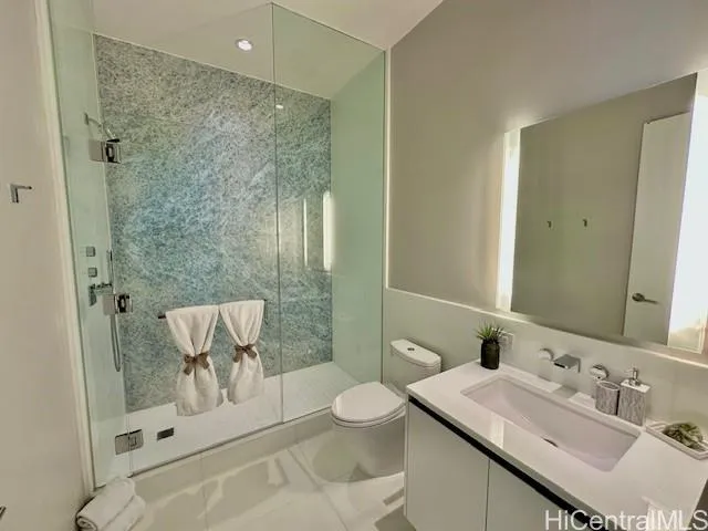 a bathroom with a sink toilet a mirror and shower