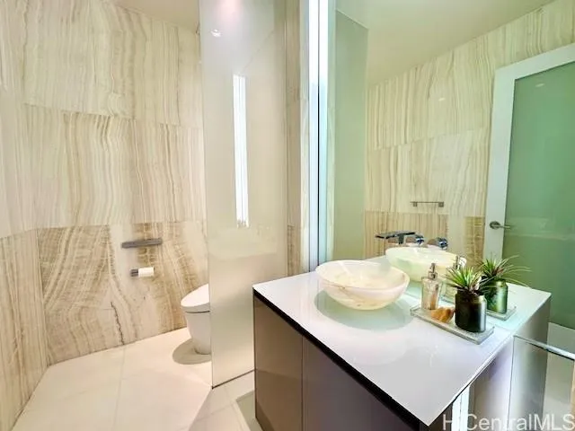 a bathroom with a sink a toilet and shower curtain