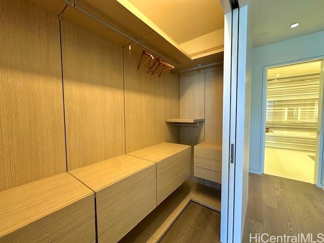 1118 Ala Moana Boulevard, Unit 3403 Honolulu, HI 96814 - Photo 19 of 24 a bedroom with a bed and wooden floor