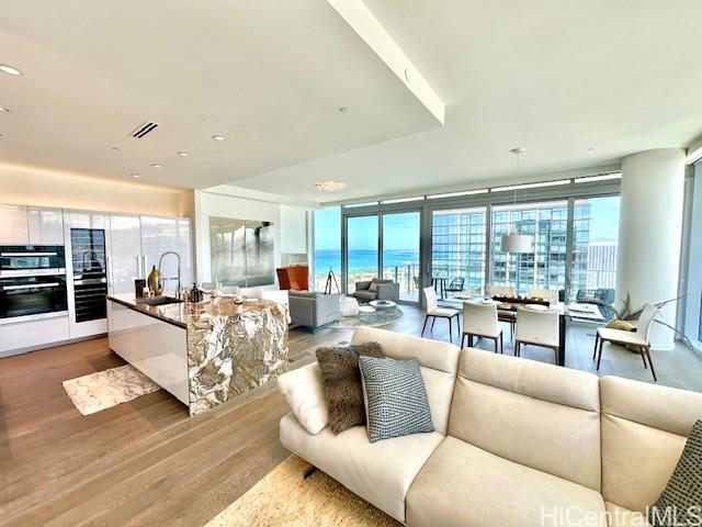 1118 Ala Moana Boulevard, Unit 3403 Honolulu, HI 96814 - Photo 2 of 24 a living room with furniture and a large window