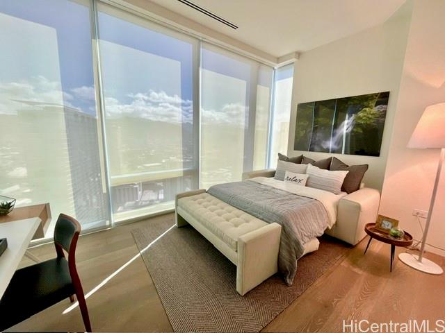 1118 Ala Moana Boulevard, Unit 3403 Honolulu, HI 96814 - Photo 23 of 24 a bedroom with a bed chair and window