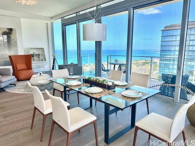 1118 Ala Moana Boulevard, Unit 3403 Honolulu, HI 96814 - Photo 5 of 24 a dining room with furniture a large window and a table