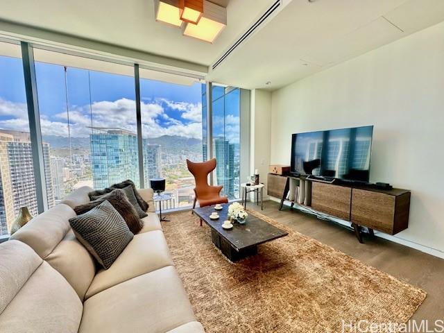 1118 Ala Moana Boulevard, Unit 3403 Honolulu, HI 96814 - Photo 7 of 24 a living room with furniture and a flat screen tv