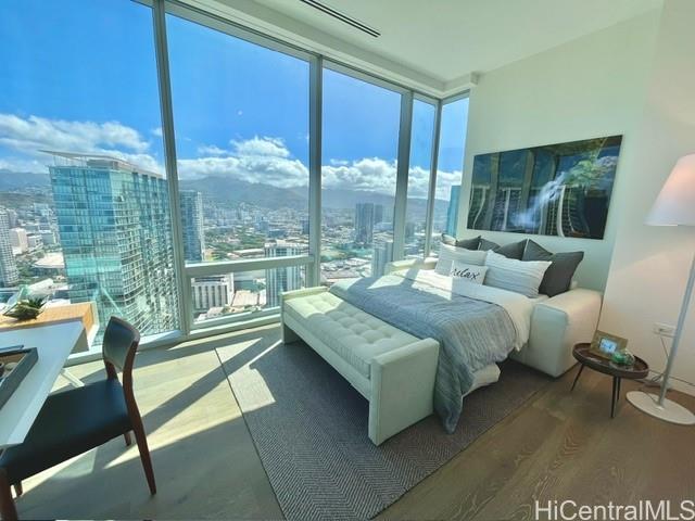 1118 Ala Moana Boulevard, Unit 3403 Honolulu, HI 96814 - Photo 8 of 24 a living room with couch and a large window