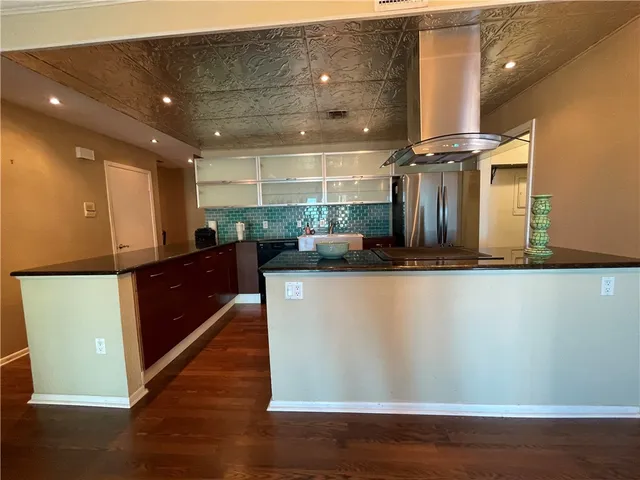 a kitchen with stainless steel appliances granite countertop a sink and a stove