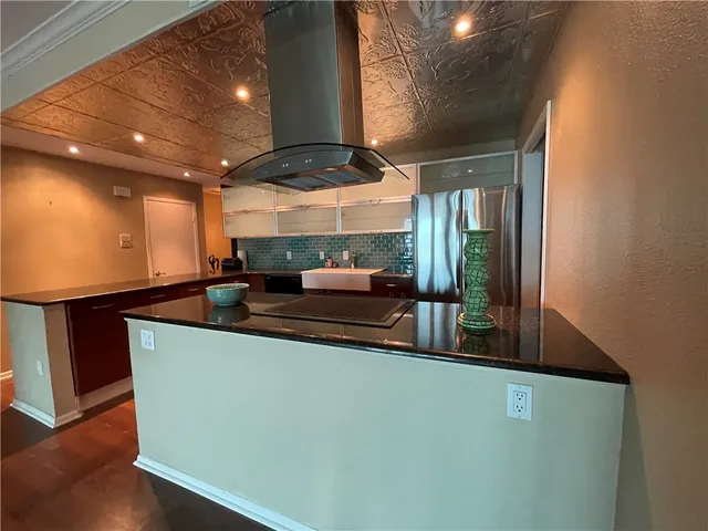 a room with lots of counter space and wooden floor