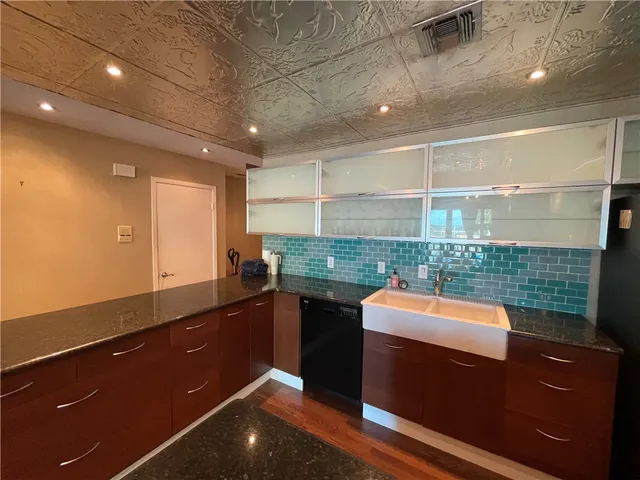 a kitchen with a sink and cabinets