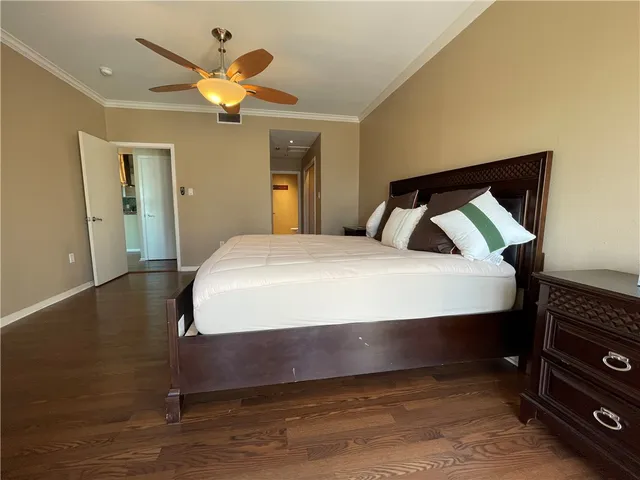 a bedroom with a bed and a ceiling fan